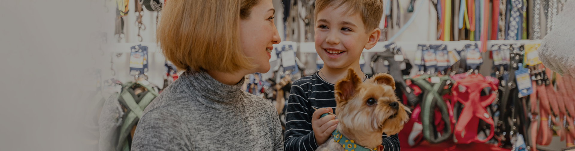 Woman and child with a dog in a pet store